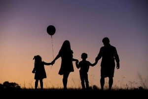 Silhouette of family and balloon