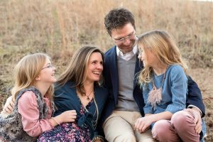 Family of four sitting in field