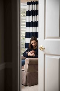 Mom nursing baby in chair