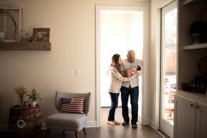 newborn baby girl with mom and dad during lifestyle newborn photography session