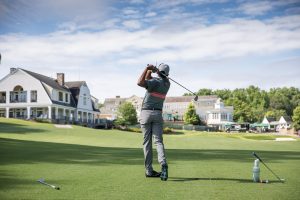 man swinging golf club