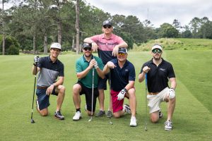 guys posing with golf clubs