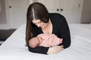 beautiful mom holding new baby
