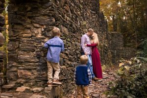 mom and dad kissing while boys look