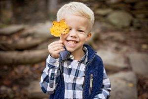 little boy holding a yellow leaf in georgia