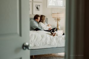 new parents in home park with dog and baby