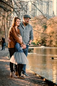 family hugs by the lake