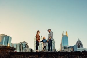 family standing on the wall with skyline background at Piedmont park