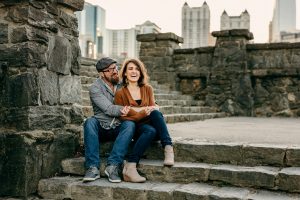 couple snuggling on the steps at Piedmont Park