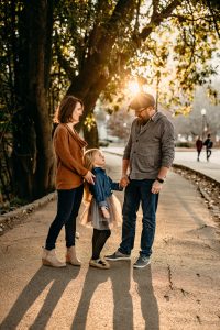 family with golden light near Piedmont park entrance