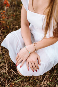 details of jewelry and nails during senior photoshoot