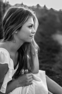 close up during senior photos of profile in field in Roswell park