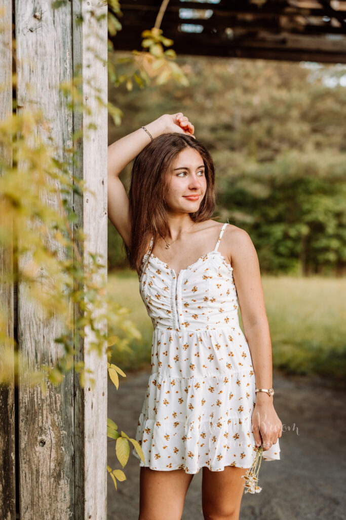 Creekview senior in a floral dress during her outdoor portrait session