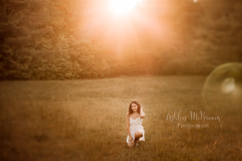 Creekview senior in a floral dress during her outdoor portrait session
