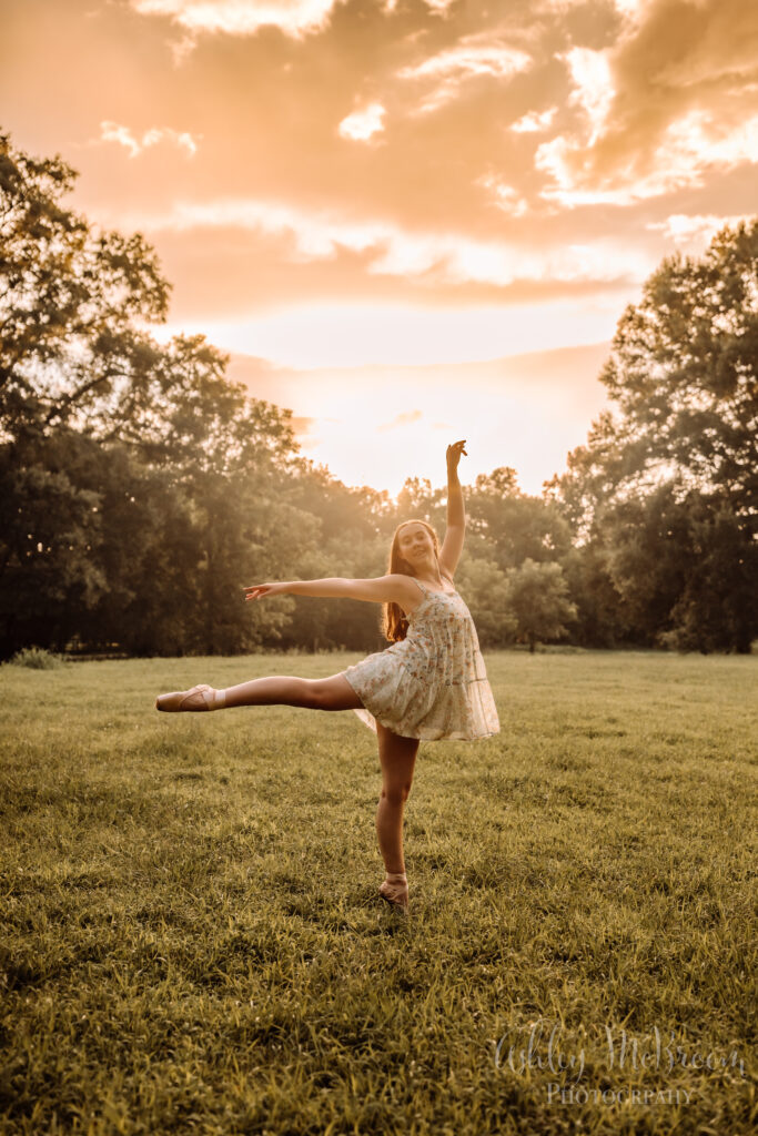 Campbell High School IB senior performing a ballet pose during her golden-hour senior portrait session in Georgia