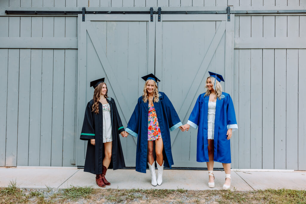 East Cobb high school senior friends celebrating together in caps and gowns