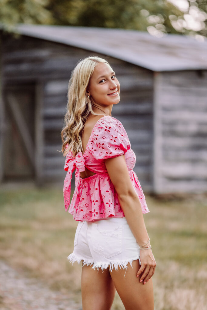 Casual Pope High School senior pictures with a rustic outdoor backdrop in Marietta