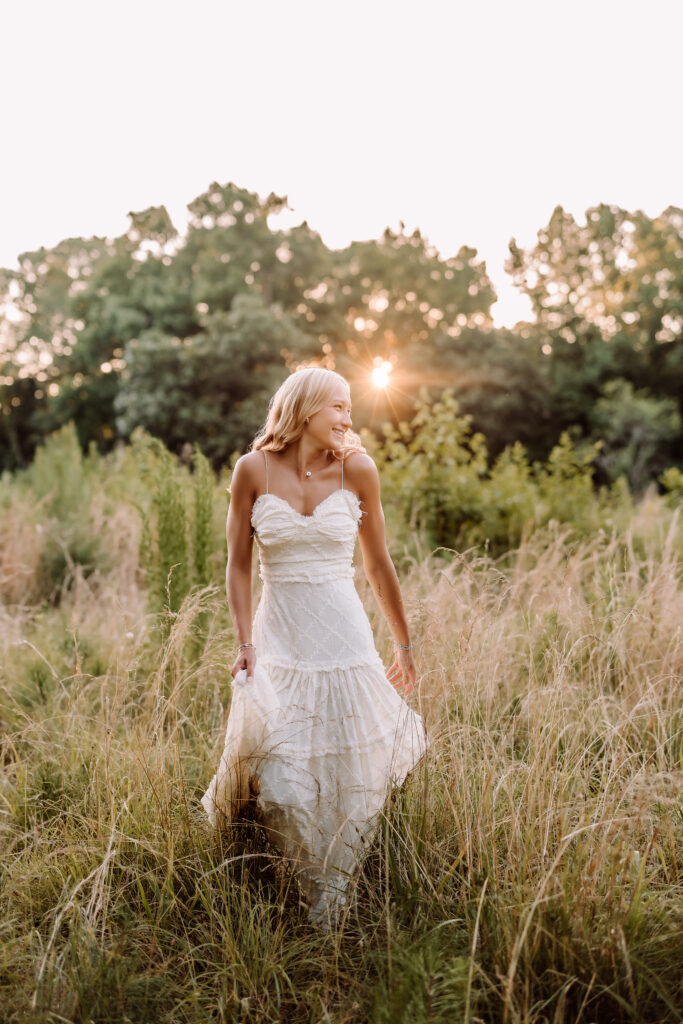 Pope High School senior pictures in a golden field at sunset in Marietta, Georgia