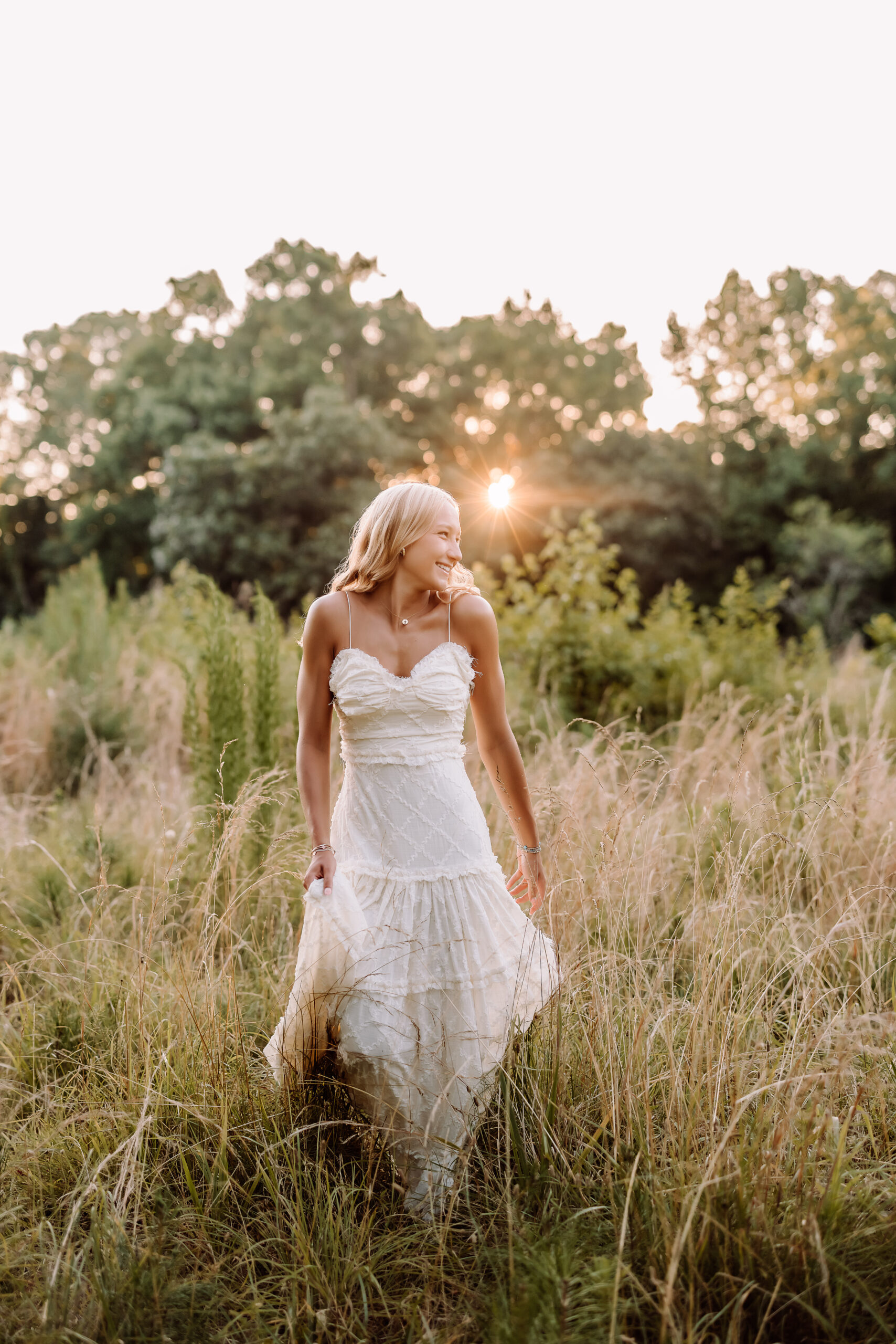 Pope High School senior pictures in a golden field at sunset in Marietta, Georgia