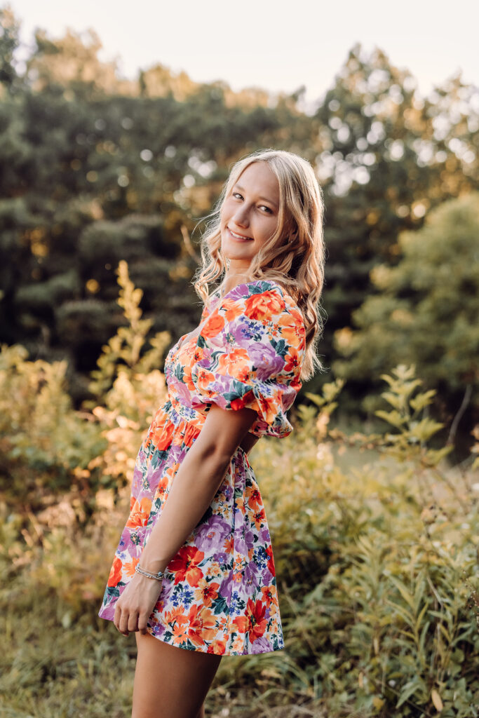 Pope High School senior portrait in a colorful floral dress outdoors in Marietta, Georgia