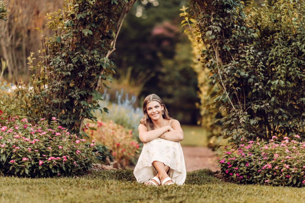 Roswell high school senior sitting amidst a beautiful garden at Barrington Hall